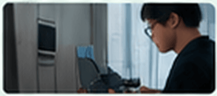 A developer coding at a desk with a monitor