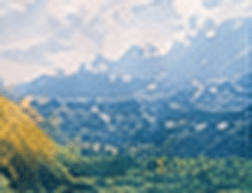Green valley and mountains at sunrise